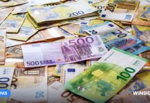 Holandsko obmedzilo vklady na 700 eur mesačne. Legálny trh sa scvrkol a licencovaným firmám ostáva len 59 percent tržieb Hráč s mobilným telefónom a eurovými bankovkami na stole